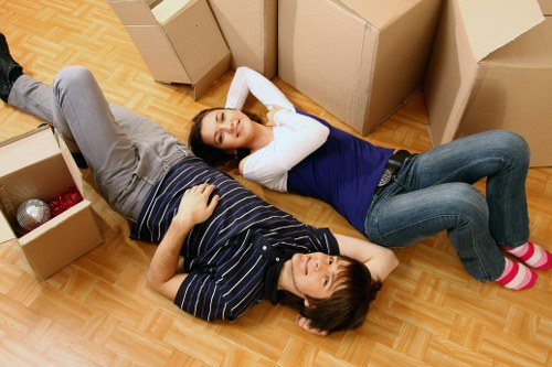 Professional movers carrying household furniture carefully